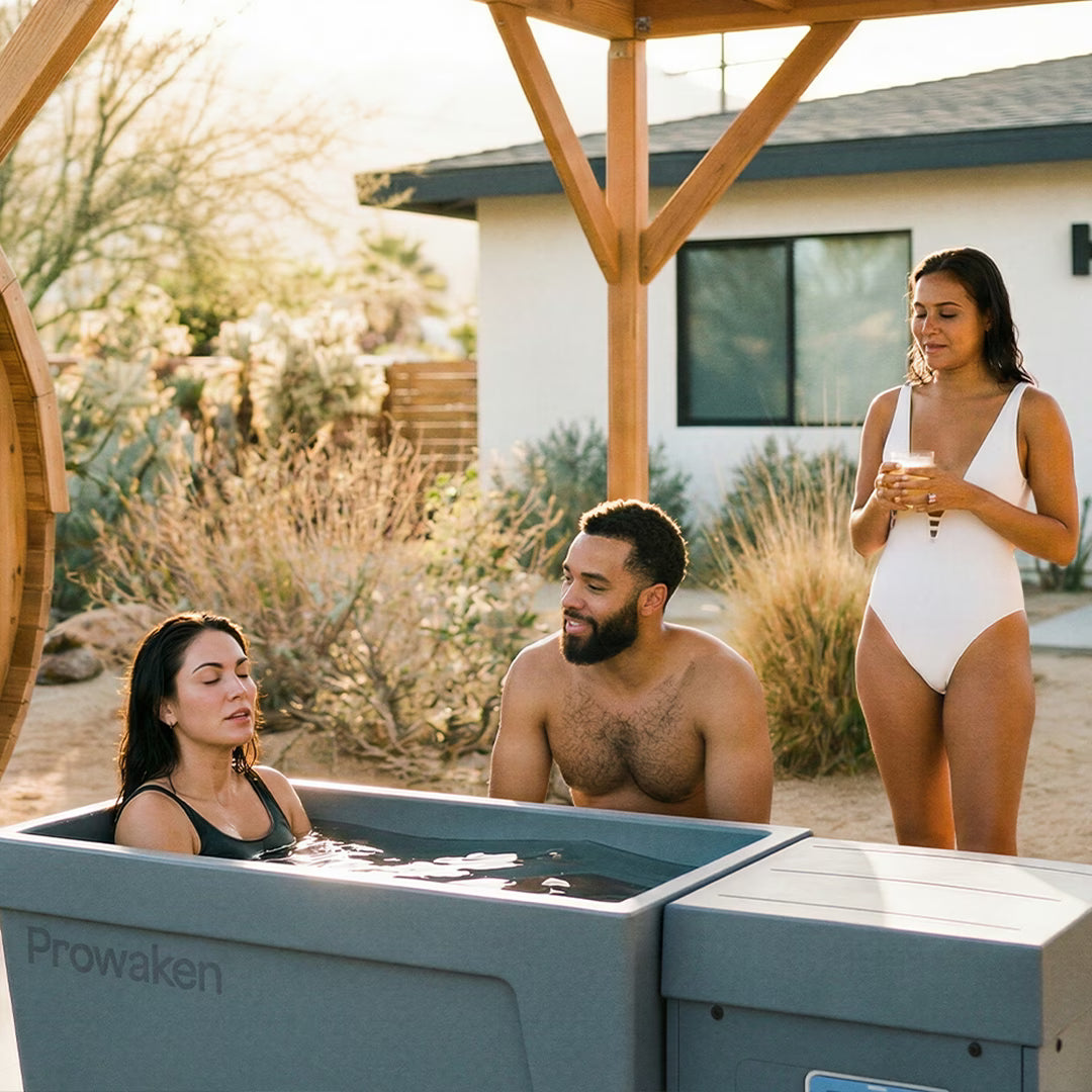 Group of friends relaxing by outdoor cold plunge tub in modern backyard setting